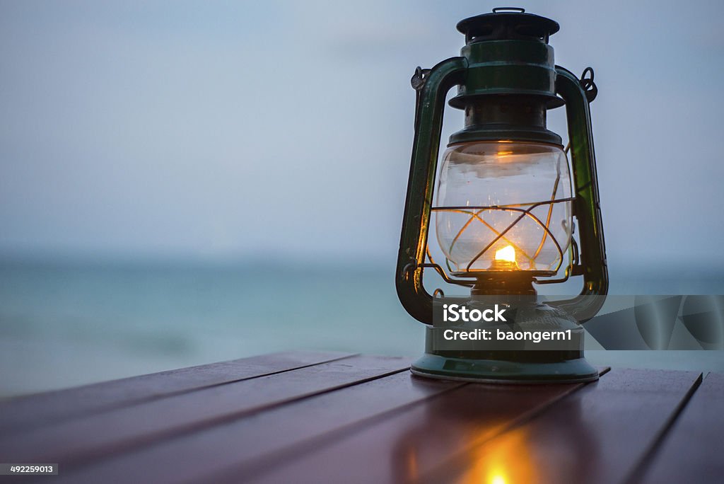 Old fashioned lantern in darkness. Light concept. Electric Lamp Stock Photo