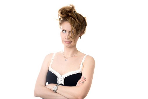 Portrait of young attractive blond woman making funny face, annoyed with her bad messy hairstyle and hair problems, studio shot, isolated on white background