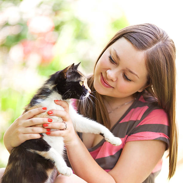 istock Young girl plays with cat 492260061