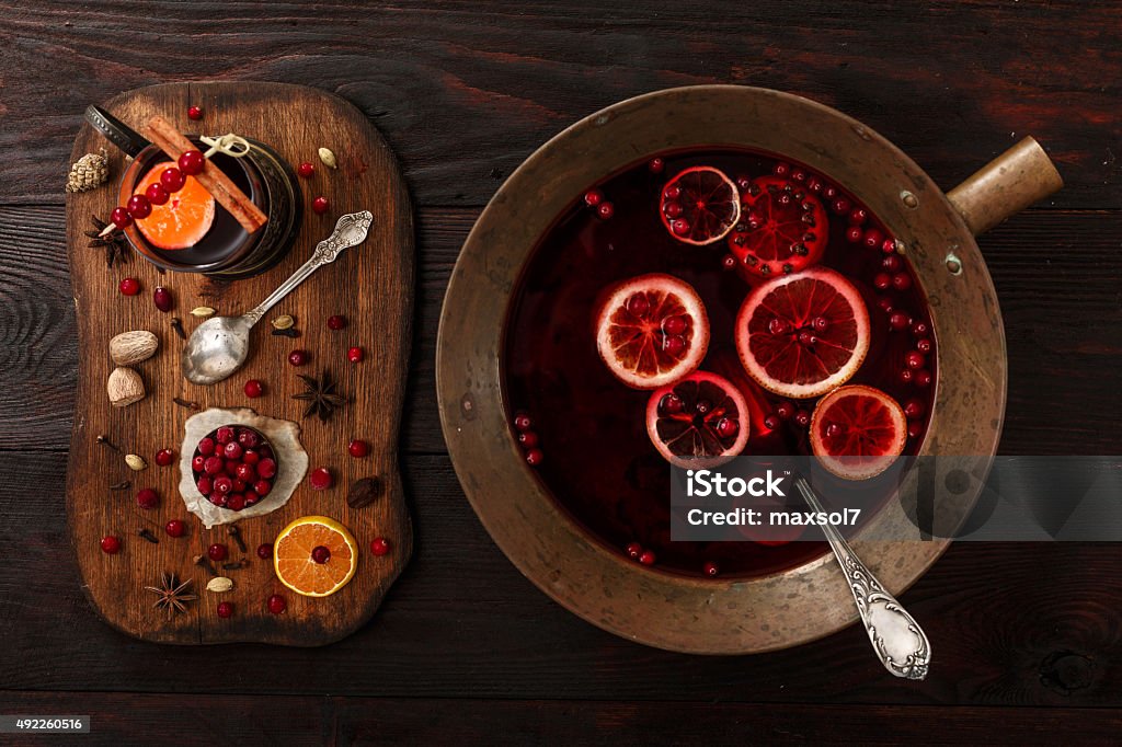 Cranberry punch Cranberry citrus punch or mulled wine with ingredients over dark wooden table. Mulled Wine Stock Photo