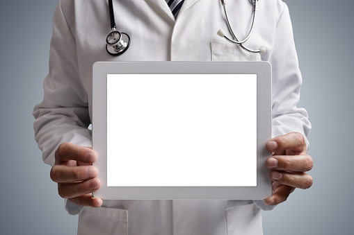 Doctor holding a blank digital tablet screen for copy medical concept