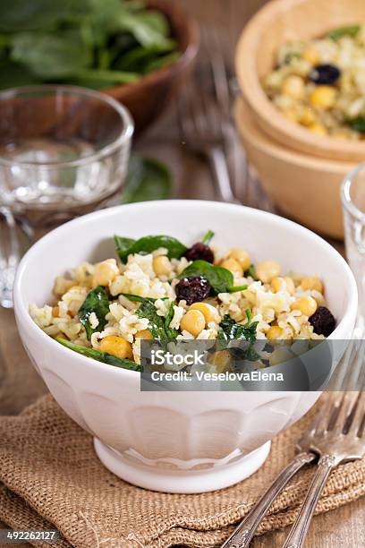 Salad With Rice Chickpeas Spinach Raisins Stock Photo - Download Image Now - Appetizer, Asian Culture, Baked