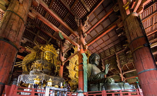 Nara, Japan - October 6, 2015: The Daibutsuden at Nara has the world's largest bronze statue of the Buddha and other two Bodhisattava (seen left).
