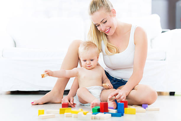 istock Mother and baby playing with blocks 492262376