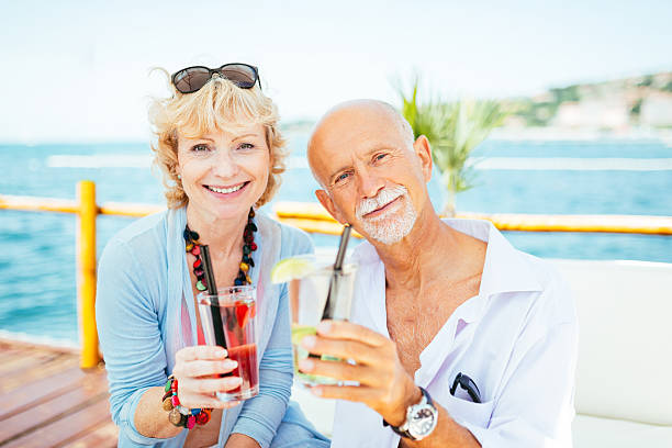 istock Happy senior couple at beach cocktail bar 492262908