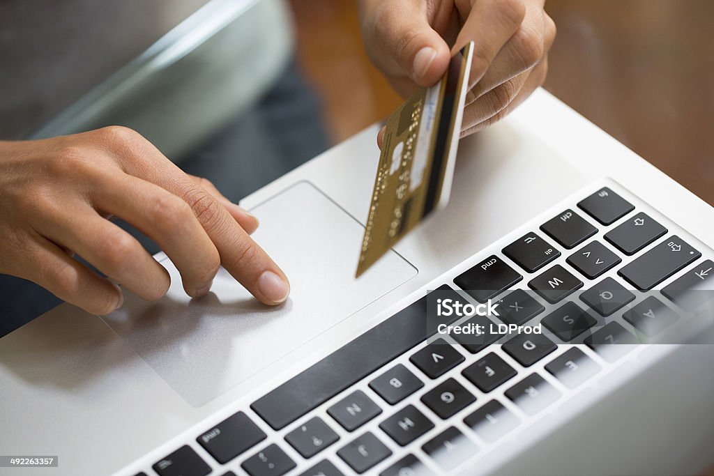 Close-up hand woman using laptop and credit card, online shopping Female keyboard computer desk fingers Online Shopping Stock Photo