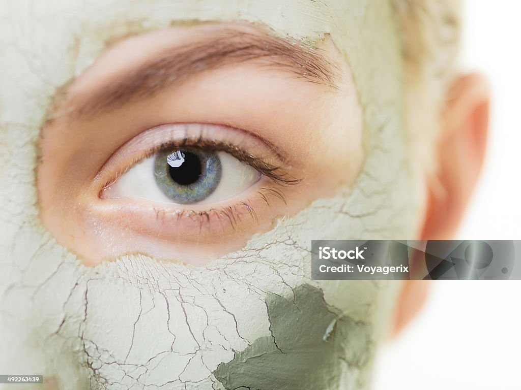 Skin care. Woman in clay mud mask on face. Beauty. Skin care. Woman in clay mud mask on face isolated on white. Girl taking care of dry complexion. Beauty treatment. Algae Stock Photo
