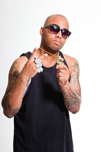 Hip hop urban gangster black man wearing dark shirt and bling bling isolated on white. Looking confident. Cool guy. Studio shot.