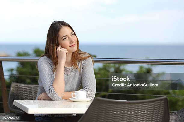 Woman Pensive Sitting In A Terrace Of A Restaurant Stock Photo - Download Image Now - Adult, Apartment, Balcony