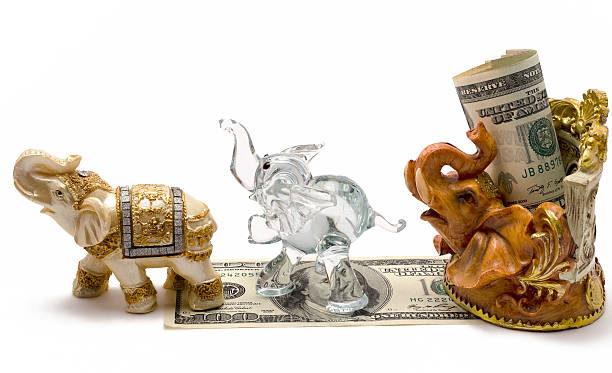 istock money with a figurine of an elephant 492266347