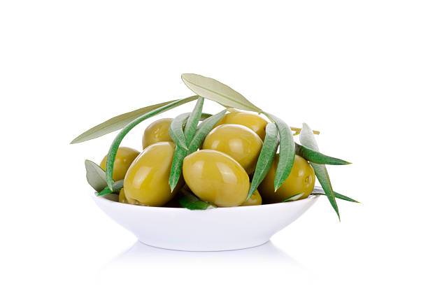 istock pickled green olives in a bowl and olive tree branch 492274410