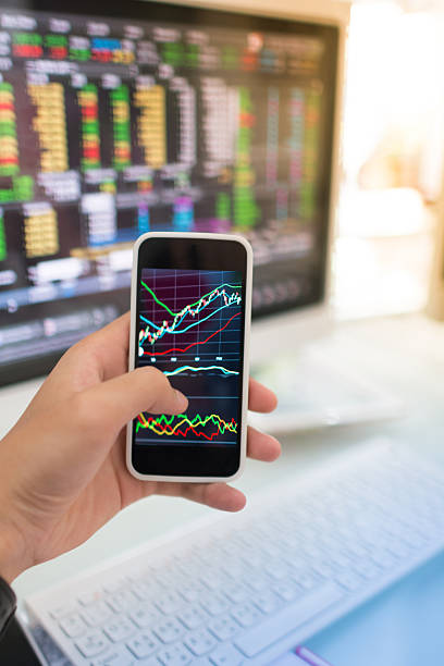 istock Using smart phone in Stock market graph and office work 492275526