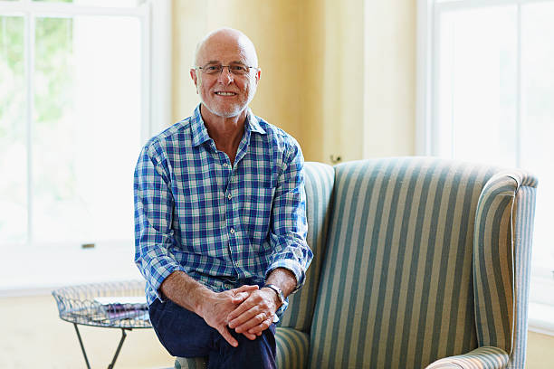 portrait of contented senior man at home - 65 69 anni foto e immagini stock