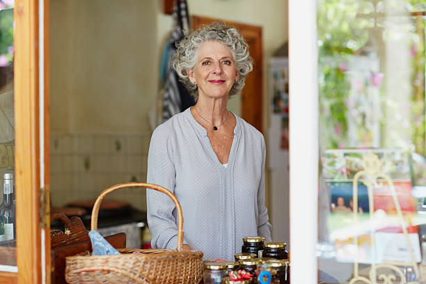 confident senior woman sitting at porch - necklace horizontal waist up outdoors foto e immagini stock