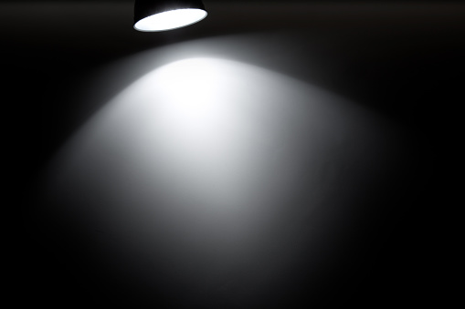 Spotlight on a black background (100% real photo)