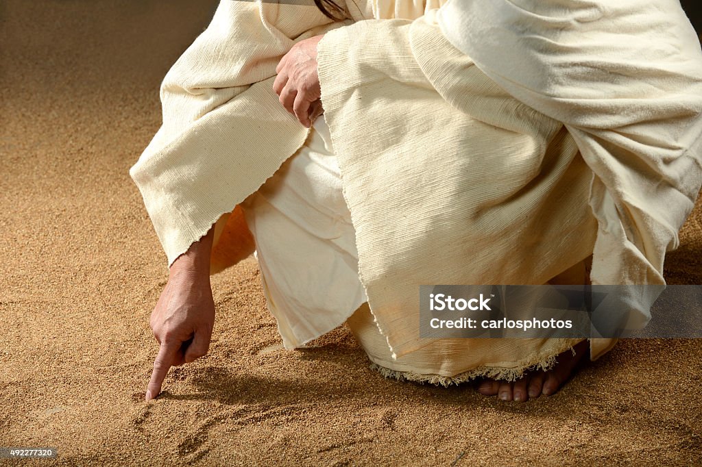 Jesus Writing won the sand Jesus Writing on the sand with his finger Jesus Christ Stock Photo