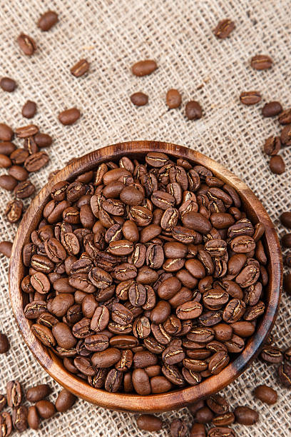 istock Coffee beans in a wooden dish on bag 492281590