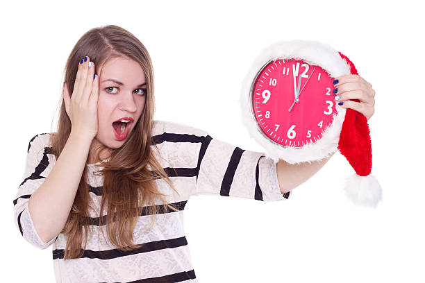 istock young woman in santa hat with clock  isolated 492282204