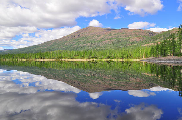 A mountain rises above low clouds and mist in the arctic along the Yukon's Dempster Highway.  Click to view similar images.