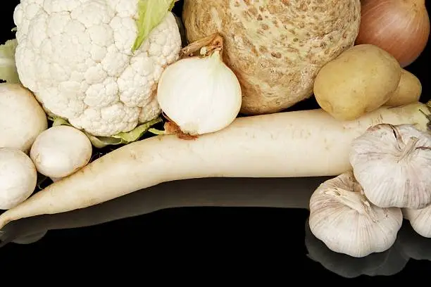 Photo of Collection of white vegetables on black top view