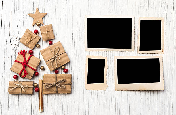 istock Christmas tree make of cardboard gift box and old photo 492284496