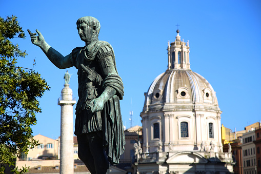 Statue S.P.Q.R. IMP.CAESARI.NERVAE.F.TRAIANO OPTIMO PRINCIPI1 and Santa Maria di Loreto in Rome, Italy