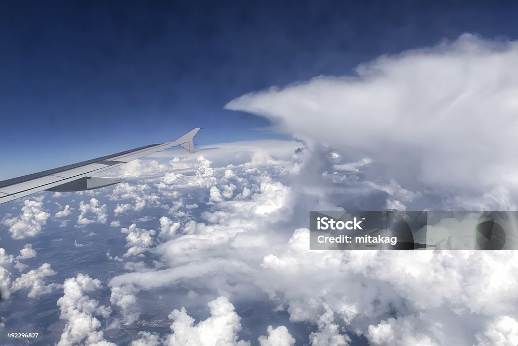 View from window of the plane View over the clouds from the window of the plane Air Vehicle Stock Photo