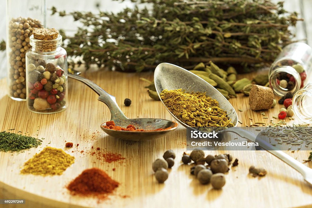 Variety of spices and herb on a wooden board Variety of spices and herb on a wooden board - selective focus Asian Culture Stock Photo