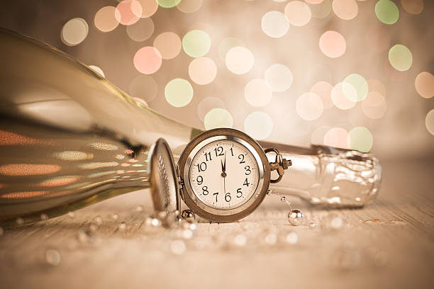 istock New Year's clock and champagne at midnight 492308018