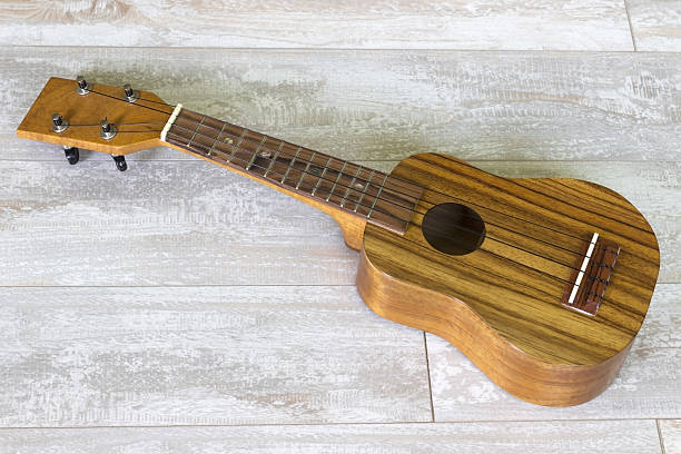 istock ukulele on wooden background 492309120