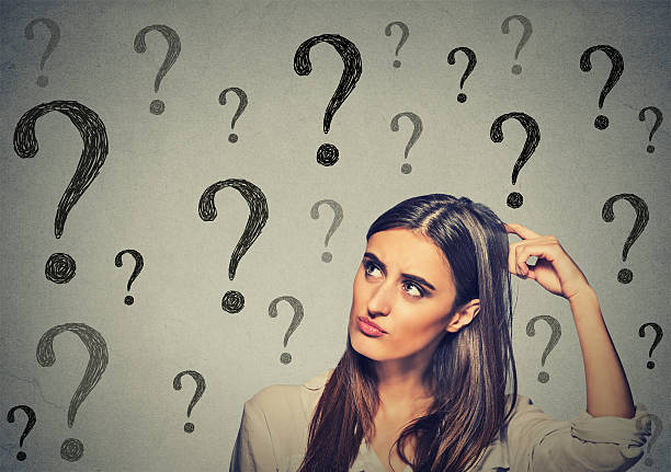 istock thinking woman scratching her head looking up at question marks 492309172