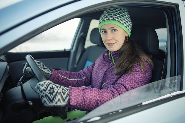 istock female driver in the car in winter 492310506