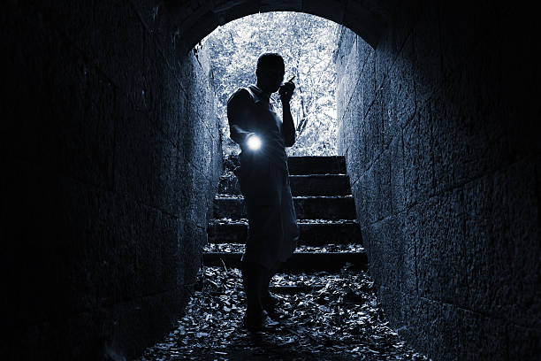 istock Young man with radio set and flashlight in tunnel 492311588