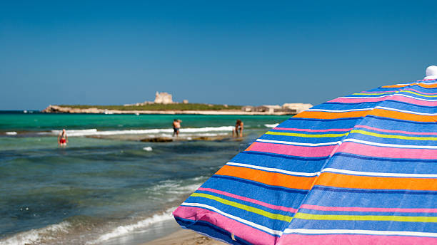 Parasol in the beach of Portopalo (southern Sicily) Parasol in the beach of Portopalo (southern Sicily); sea in the background portopalo stock pictures, royalty-free photos & images
