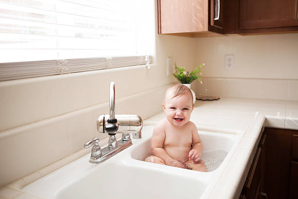 istock Cute Baby in Kitchen Sink 492313312