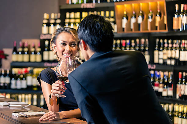 istock Asian couple drinking red wine 492314710