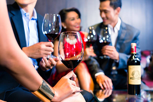 istock Asian Friends drinking wine in bar 492314982