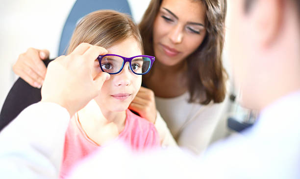 istock Little girl at optician's office. 492315710