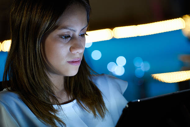istock Latina Teenager Using Tablet PC Indoor At Night 492316454