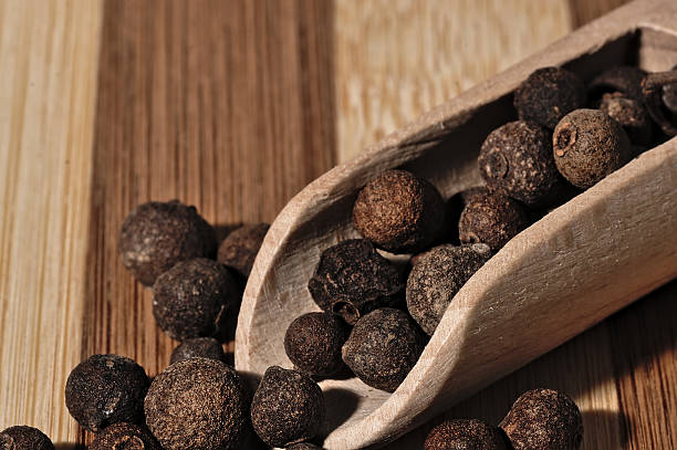 istock Grains allspice on a wooden board. 492317756