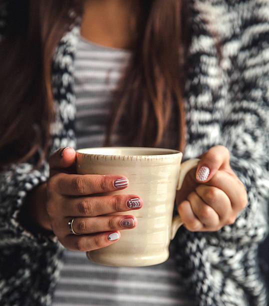 istock Girl's hands holding a cup of coffee 492318636