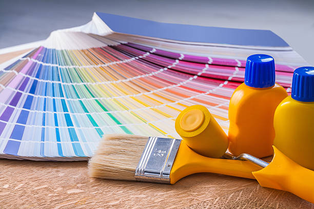 istock bottles of paint paintbrush paintroller color palette 492318720