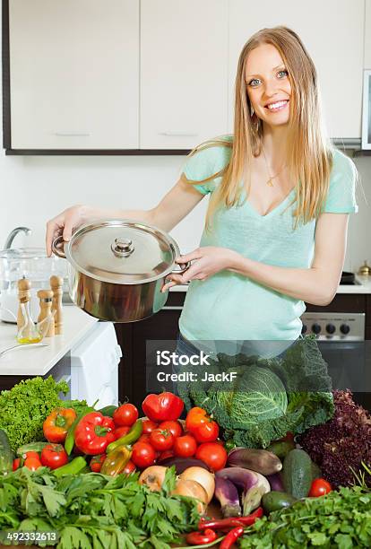 Happy Blonde Woman With Pan And Vegetables Stock Photo - Download Image Now - 20-24 Years, 20-29 Years, Abundance