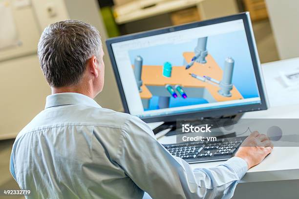 Engineer Working On Computer Stock Photo - Download Image Now - Over The Shoulder View, Engineer, Using Computer