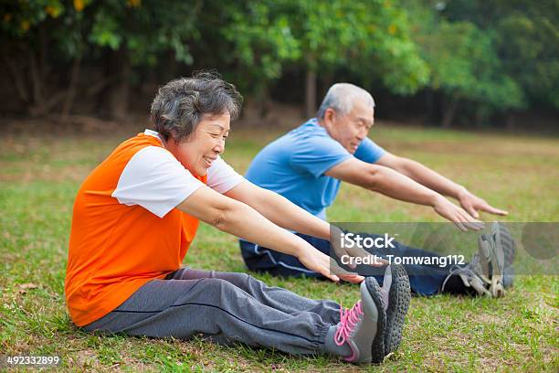 Happy Elderly Seniors Couple Working Out In Park Stock Photo - Download Image Now - Asia, Exercising, Relaxation Exercise