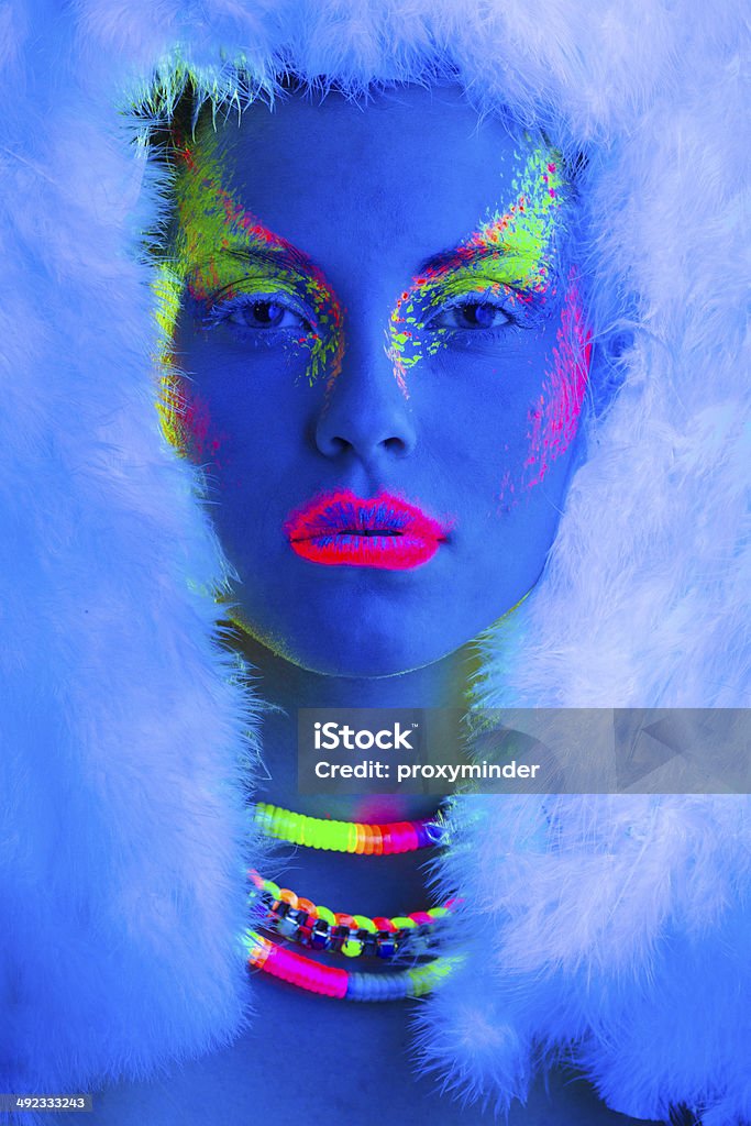 Women Portrait in Ultraviolet Light Young women portrait in Ultraviolet Light with Multi Colored makeup Neon Colored Stock Photo