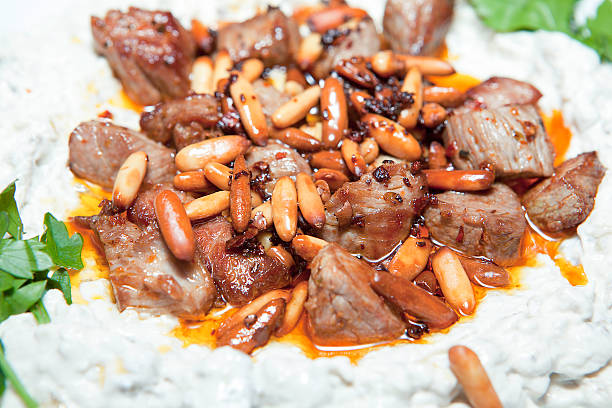 Hunkar Begendi Traditional Turkish food with grilled meat on top of eggplant salad. hunkar begendi stock pictures, royalty-free photos & images