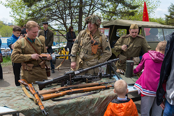 \nVladivostok, Russia - May 9, 2014: Children inspect weapons since World War II during festivities devoted to Victory Day.\n
