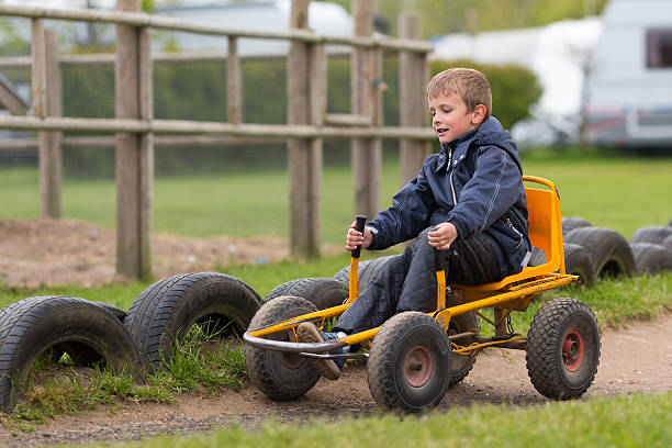 Boy having fun with buggy cart. Trademarks have been removed.