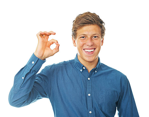 istock Young man showing an ok sign smiling wide 492339359